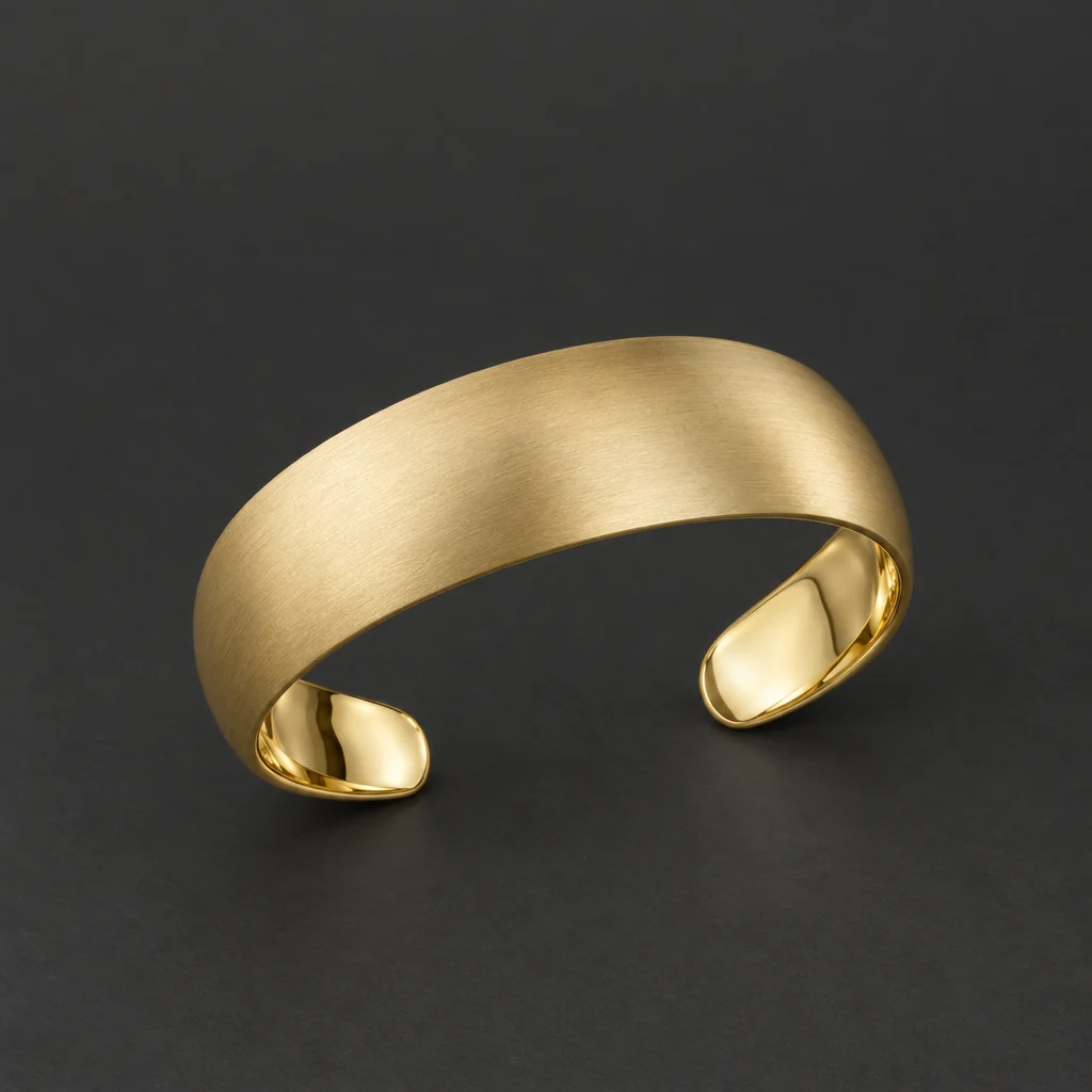 Brushed gold open cuff — Studio jewelry concept showing metal finish and connected components