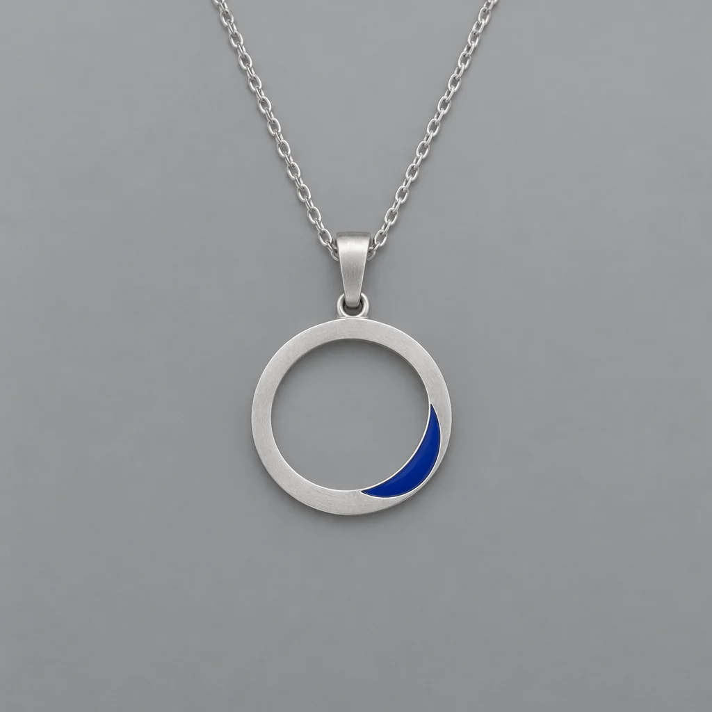 Silver pendant with blue enamel — Studio jewelry concept showing metal finish and connected components